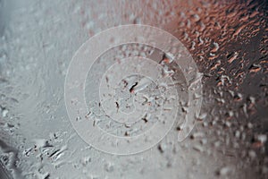 Texture Background Of Raindrops On A Glass Or Window With Red Light In The Upper Right Top