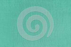 Texture background of turquoise linen fabric, cloth surface, weaving of natural cotton fabric