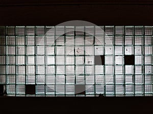 Texture background wall made of many glass cubes with black fields photo