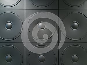 Texture background of wall with square panels with round speakers