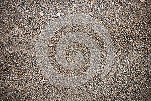 The texture of the beach with coarse sand. The texture of the pebble beach