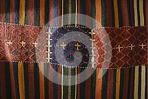 Texture of bedouin traditional wool carpet with geometric patter