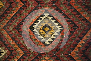 Texture of bedouin traditional wool carpet with geometric patter