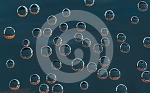 Texture of blue airbubbles with orange reflection