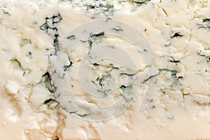 Texture of the blue cheese with blue-grey mold close-up