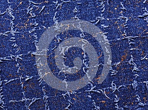 Texture of blue denim with gold threads