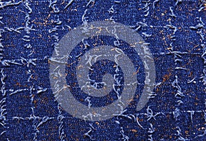 Texture of blue denim with gold threads