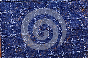 Texture of blue denim with gold threads