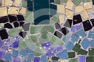 Texture of blue, yellow, green and black pieces of old tiles. Mosaic background