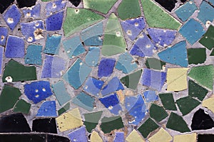 Texture of blue, yellow, green and black pieces of old tiles. Mosaic background