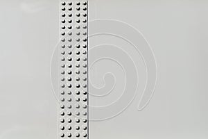 Texture of bolted connection of white-painted metal beams with free space