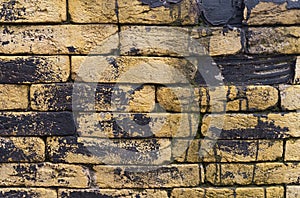 Texture of a brick wall with black paint totec elements.