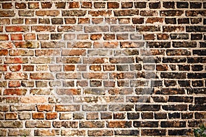 The texture of a brick wall covered with black soot.