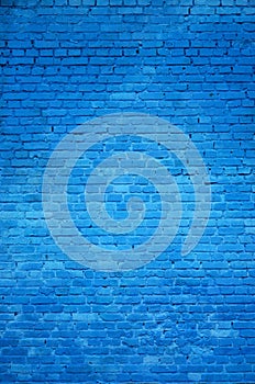 The texture of the brick wall of many rows of bricks painted in blue colo