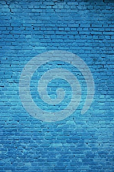 The texture of the brick wall of many rows of bricks painted in blue color