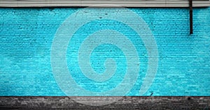 The texture of the brick wall of many rows of bricks painted in cyan colo