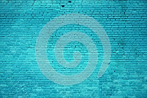 The texture of the brick wall of many rows of bricks painted in cyan colo