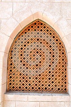 texture of the brick wall and the wooden brown old man of the ancient carved Arab Islamic Islamic triangular window with ornament