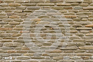 texture of bricks on the wall in the form of wild stone Background. Beige and brown tones with shadows and deep texture. Facing