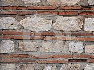 Texture of brickwork and stone masonry. Background of an old wall. Combination of plinths and limestone as as building materials