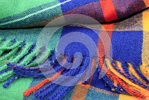 Texture of a bright multicolor scarf with fringe