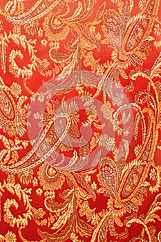 texture of bright red fabric with cucumbers