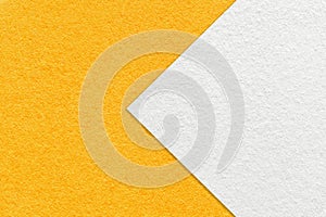 Texture of bright yellow paper background, half two colors with white arrow. Structure of craft orange cardboard