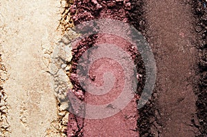 Texture of broken eyeshadow or powder. The concept of fashion and beauty industry. Close-up.