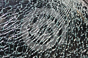 Texture of broken glass on dark background. Closeup