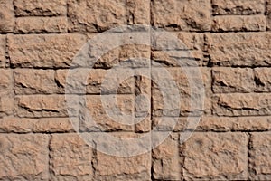 Texture of brown brick veneer wall with random layout