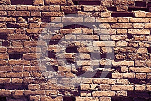 Texture of brown old brick. Background broken brickwork. Broken brown brick with