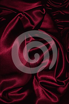 Texture of burgundy satin close up photo