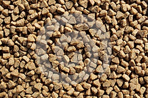 Texture of cat food in the shape of a brown heart