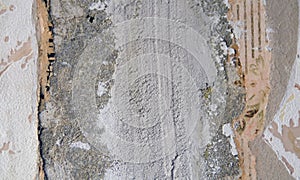 The texture of the cement beneath old Wallpaper.