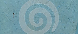 The texture of the cement wall with blue paint, the background of the cement wall with blue paint, taken from a close-up