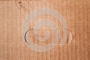 Texture of clean damaged brown cardboard box with cutted handle