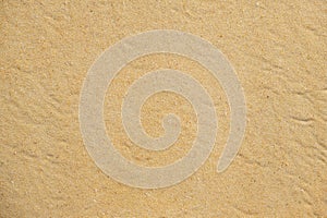 Texture of coarse yellow sand on the beach