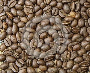 Texture of coffee beans scattered on bamboo photo