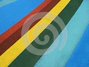 Texture of color rubber floor on playground. Safety Surfacing. Blue, red, green and yellow rubber crumb surface texture background