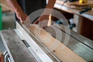 Texture of color wood dust sparks over the table, view in the carpenter workshop