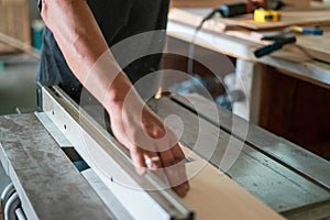 Texture of color wood dust sparks over the table, view in the carpenter workshop