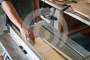 Texture of color wood dust sparks over the table, view in the carpenter workshop