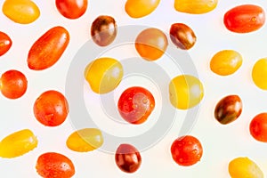 Texture of colorful cherry tomatoes red, garnet and yellow, fresh and raw. With water drops Isolated on white background