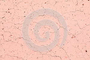 Texture of a concrete pink, wall with bumps, cracks, splashes. Abstract background. Copy space