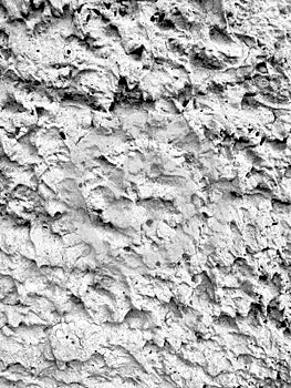 The texture of the concrete wall is gray. uneven bumpy surface close to the background