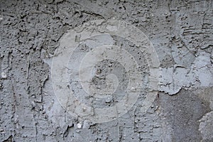 The texture of a concrete wall, unevenly plastered, spots from dampness, roughness and irregularities.