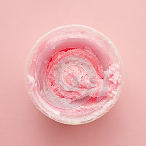 Texture cosmetic scrub for face and body pink sugar. Selective focus, trendy punchy pastel background