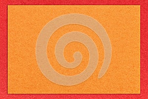Texture of craft bright orange color paper background with red border, macro. Vintage dense kraft ginger cardboard