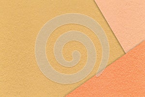 Texture of craft dark yellow paper background with peach and coral border. Vintage abstract ocher cardboard photo