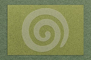 Texture of craft green paper background with dark olive border. Structure of vintage cardboard with empty frame